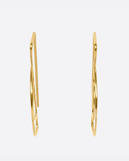 Gold wire half circle hook earrings, side view of the pair showing the slim profile