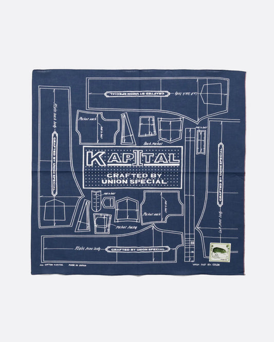 A navy cotton bandana with a  pattern for a Barbie sized outfit in white and 'KAPITAL CRAFTED BY UNION SPECIAL' at the center. Shown from the front.