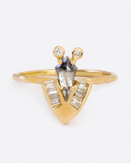 A yellow gold ring with a rose cut salt and pepper kite diamond, baguette diamonds, and round diamonds. Shown from the front.