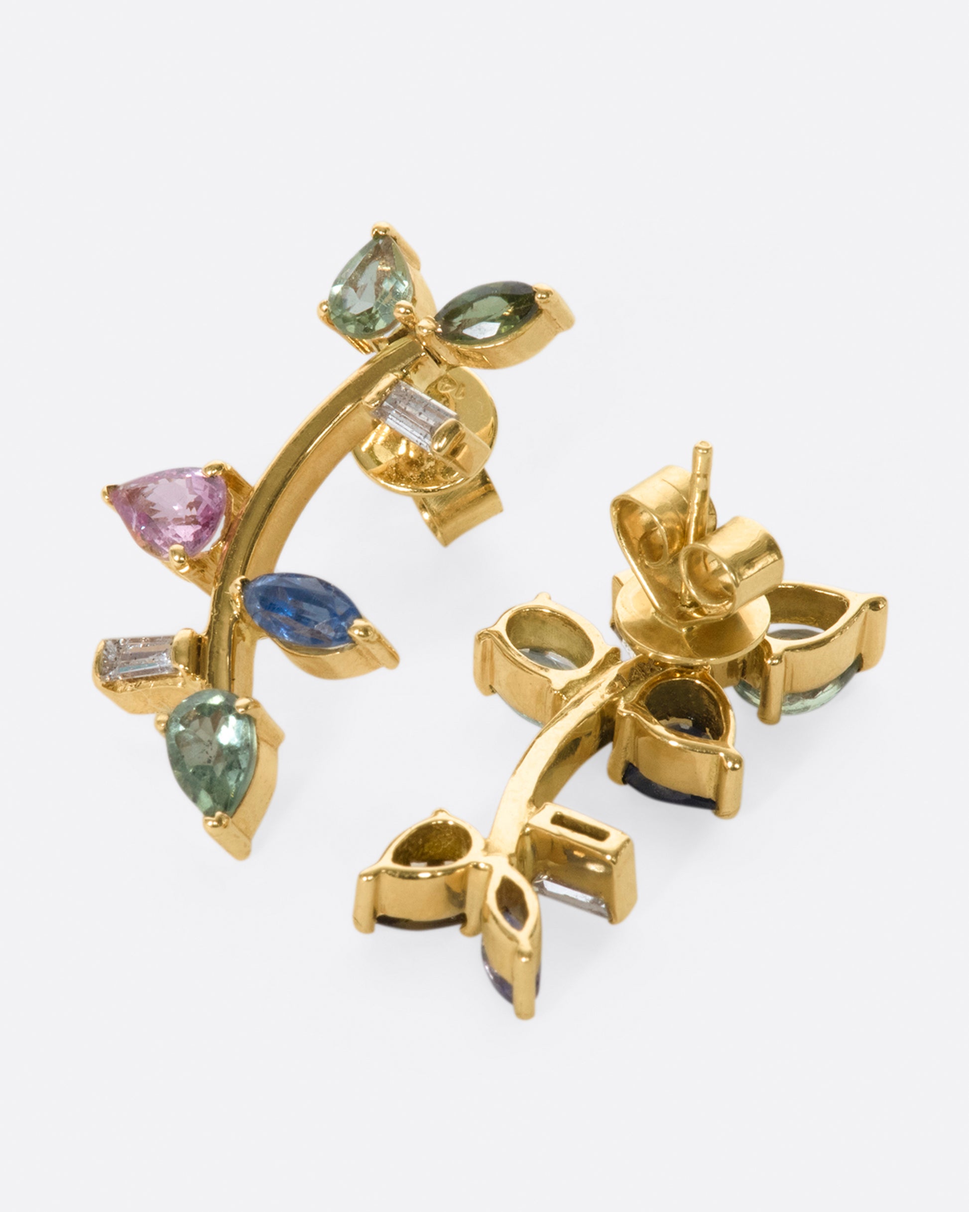 This elegant 14k gold stud, dotted with blue and green gemstones, reminds us of an olive branch