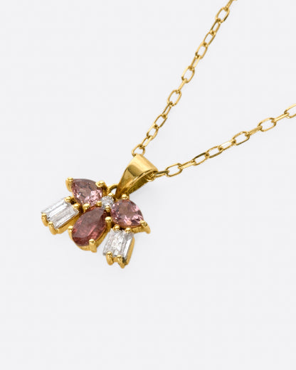 Yellow gold pink stone and diamond cluster necklace, angled view of the cluster