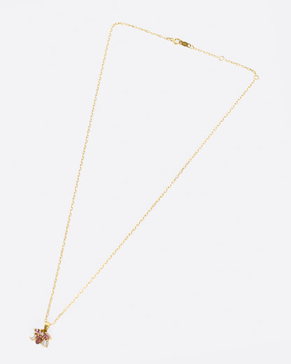 Yellow gold pink stone and diamond cluster necklace laid flat, showing the chain length and clasp