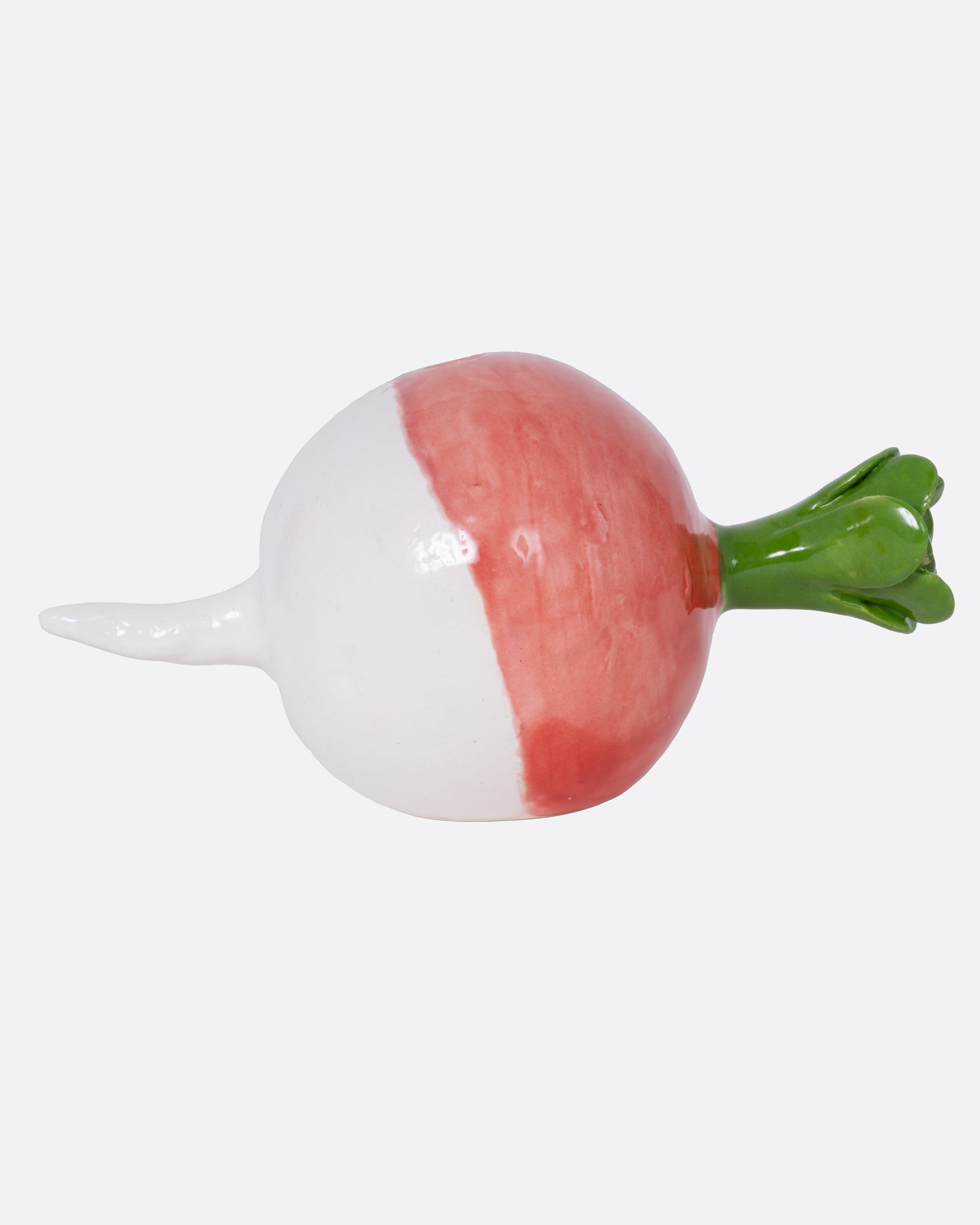 A ceramic radish candle  holder, shown from the side.