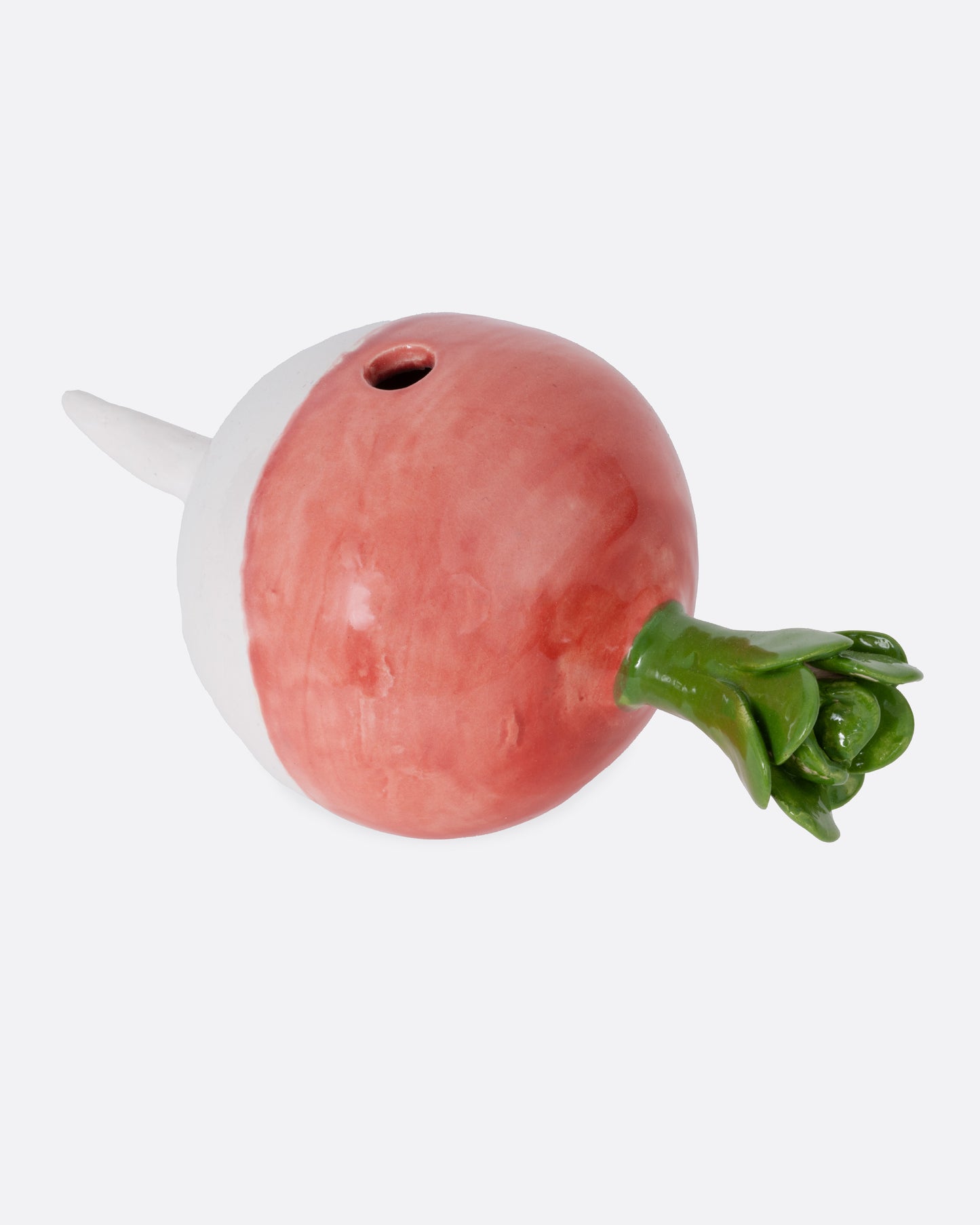 A ceramic radish candle  holder, shown from the side.