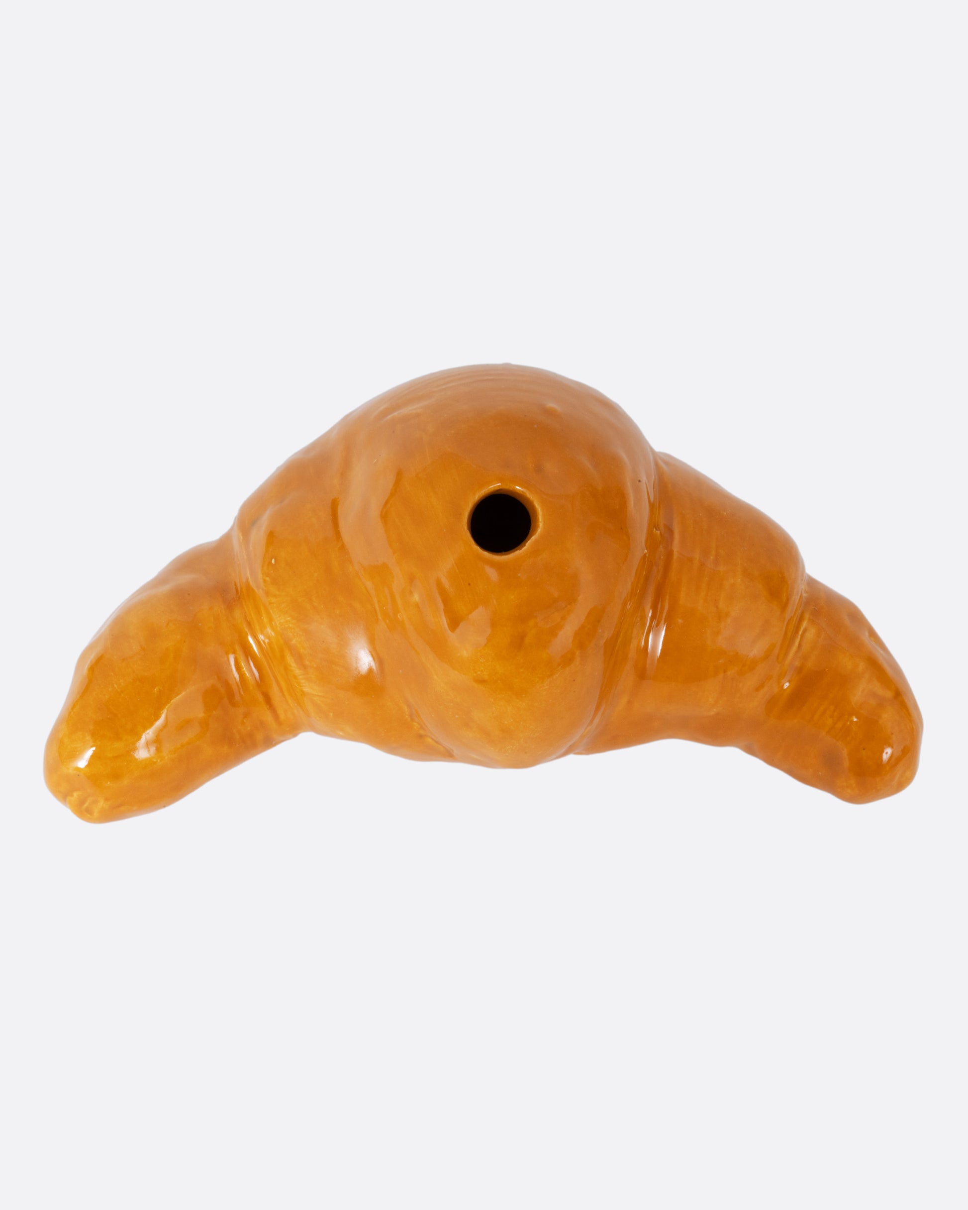 A croissant shaped candle holder, shown from the top.