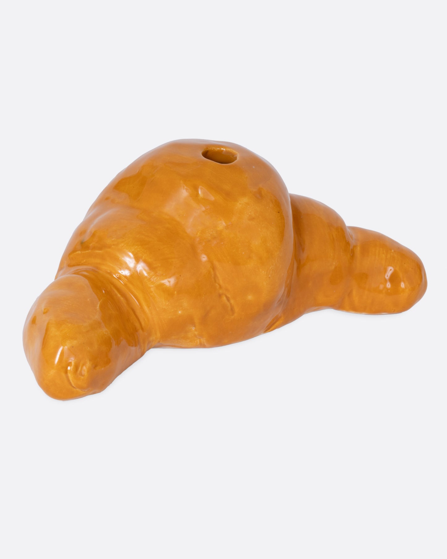 A croissant shaped candle holder, shown from the front.