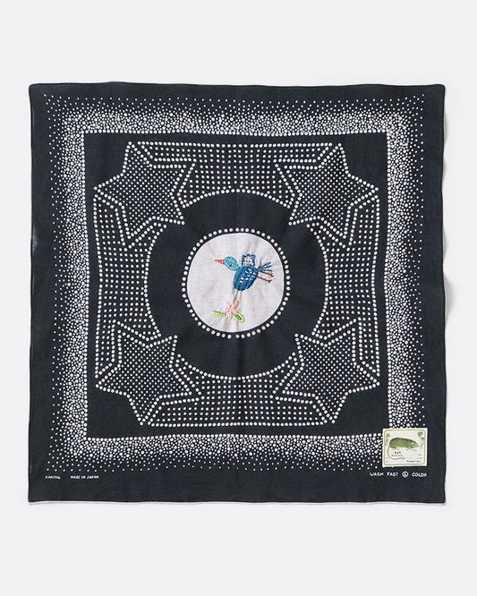 A black bandana with a spotted star motif and a hand- embroidered magpie at the center. Shown from the front. 