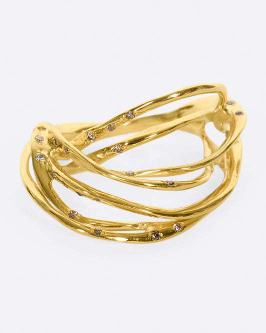 A yellow gold ring formed from multiple strands of gold, dotted with cognac diamonds. Shown from the front.