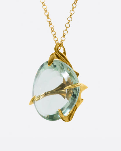 Yellow gold and green quartz necklace, angled view of the gold branches wrapping the edge of the quartz