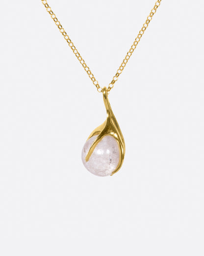 Yellow gold and pink tourmaline pendant necklace hanging from its chain