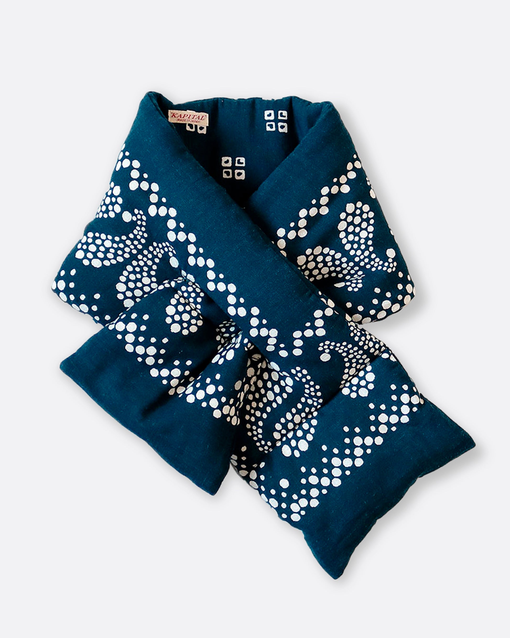 An insulated blue and white paisley printed bandana scarf with an opening at one end, shown pulled through itself.