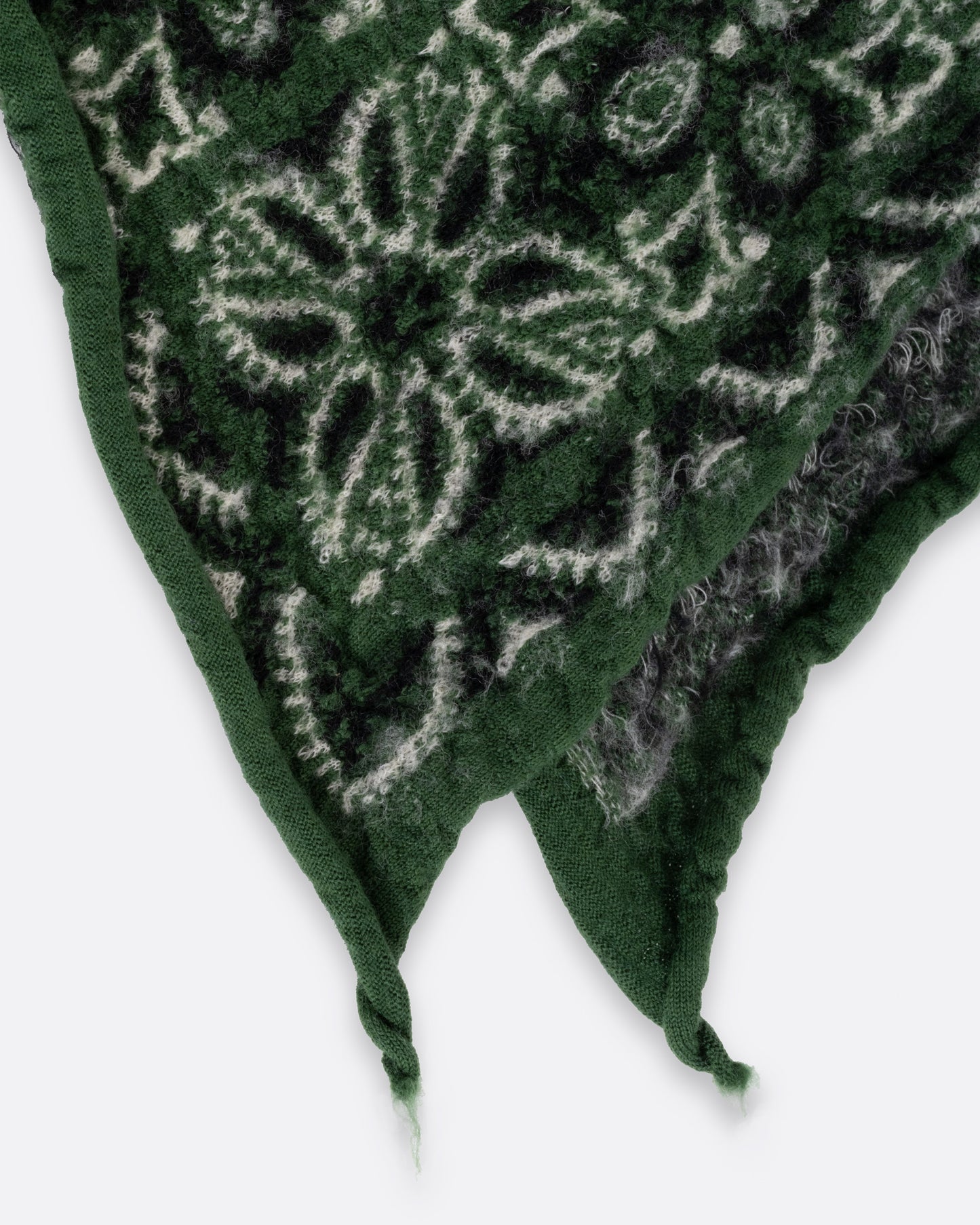 A close up of a green compressed wool scarf with a classic bandana pattern.