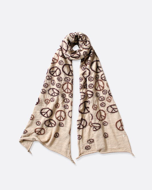 A compressed beige wool scarf with brown peace signs all over it. Shown wrapped in a loop from the front.