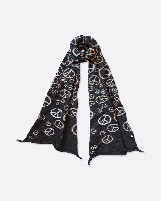 A black compressed wool scarf with a pattern of white peace signs, shown looped.