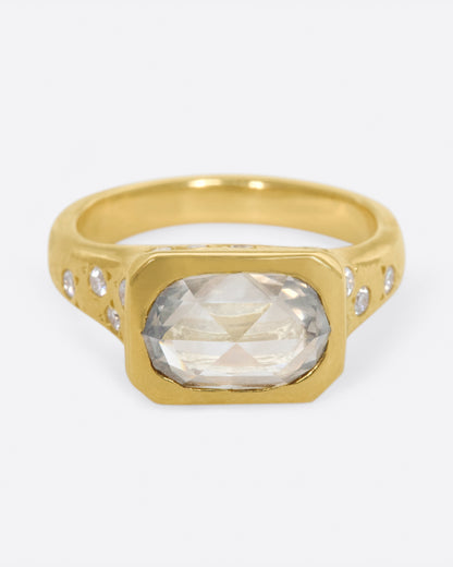 Yellow gold oval diamond ring, front view of the oval rose-cut diamond and star-set side diamonds