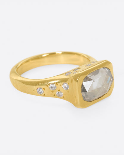 Yellow gold oval diamond ring, side view with the oval diamond facing right