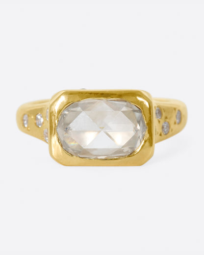 Kimberlin Brown Starry ring in yellow gold, an oval rose-cut diamond bezel set in a rectangular frame with small diamonds scattered on the band