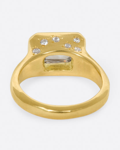 Yellow gold oval diamond ring, back view showing the open gallery under the diamond and the star-set diamonds
