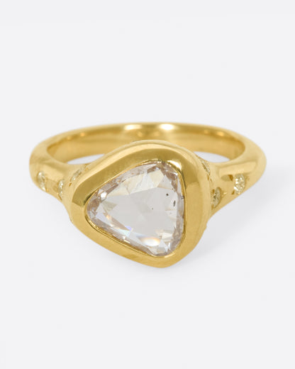 Yellow gold trillion diamond ring, front view of the trillion diamond and star-set side diamonds
