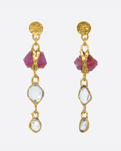 Lou Zeldis earrings in 22k yellow gold, a rough ruby wrapped in gold above two Herkimer diamond crystals hanging from textured disc studs