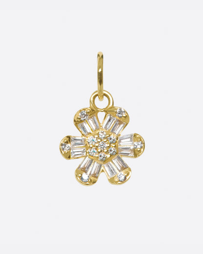 Yellow gold daisy charm, a flower with baguette diamond petals around a pave diamond center, on a gold jump ring