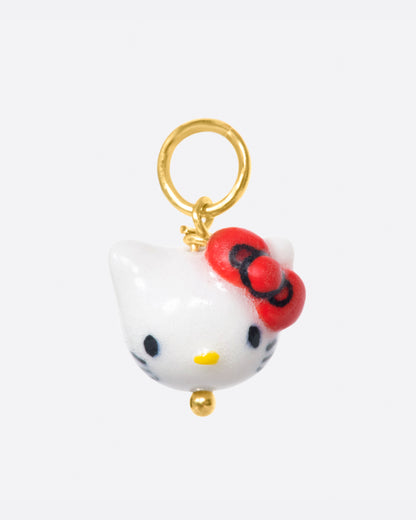 OKS glazed porcelain Hello Kitty head charm, a white cat face with a red bow, on a gold jump ring