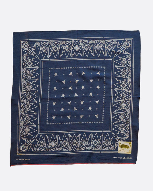 A navy blue bandana with a white pattern of paper cranes. Shown open lying flat.