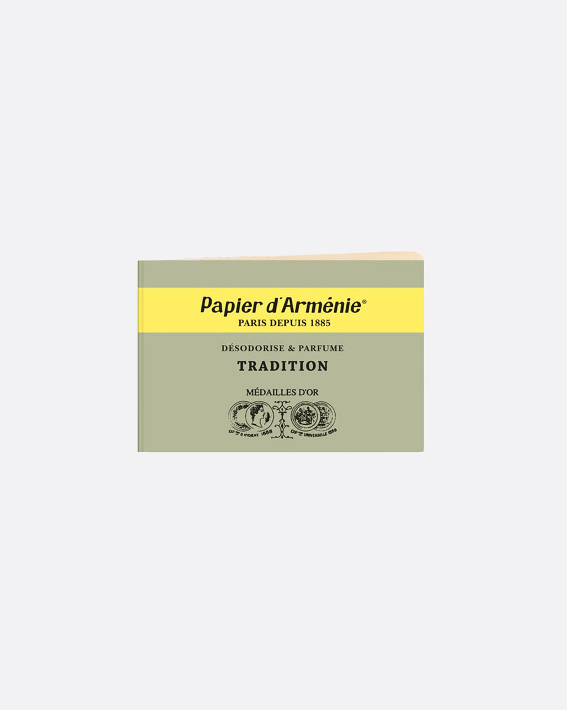 A green and yellow booklet of paper incense. The front reads: 'Paper d'Arménie PARIS DEPUIS 1885 DÉSODORISE & PARFUME TRADITION MÉDAILLE D'OR' and has medallion imagery at the bottom. Shown from the front.