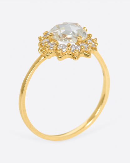 Yellow gold diamond halo ring, angled view showing the height of the halo setting