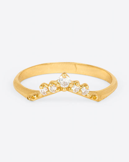 A yellow gold ring with an arched front and five diamonds. Shown from the front.