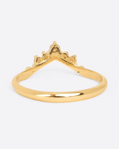 A yellow gold ring with an arched front and five diamonds. Shown from the back.