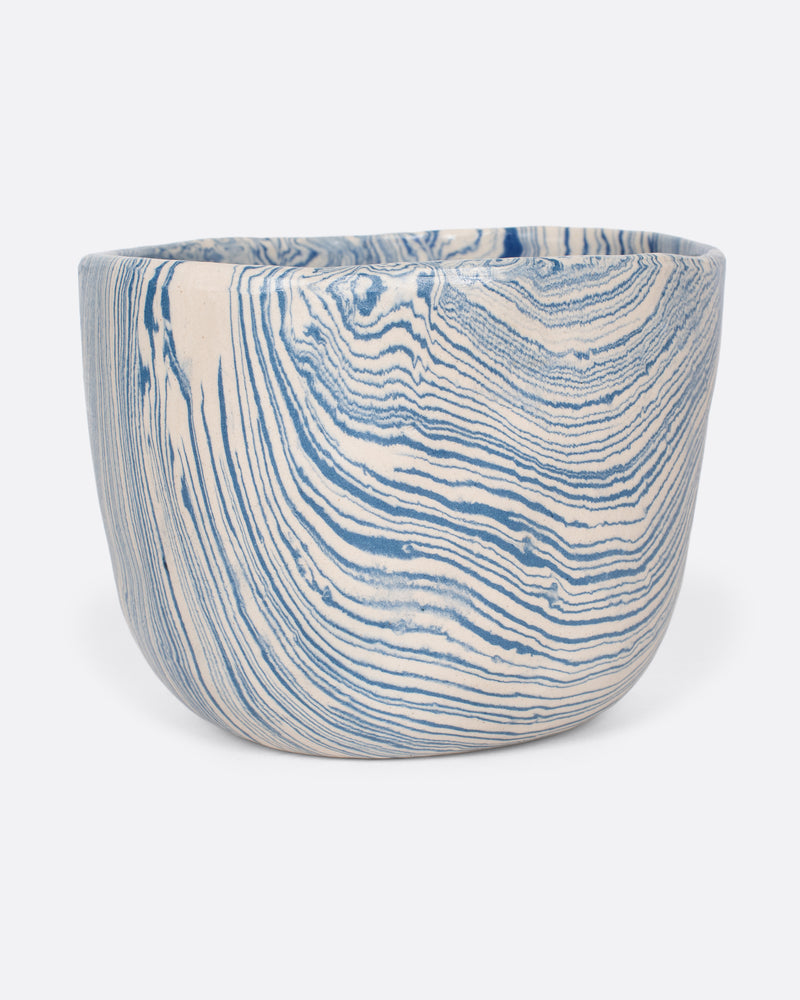 Sam Andrew nerikomi bowl in blue narrow stripes, a handmade bowl with swirling marbled blue and cream clay