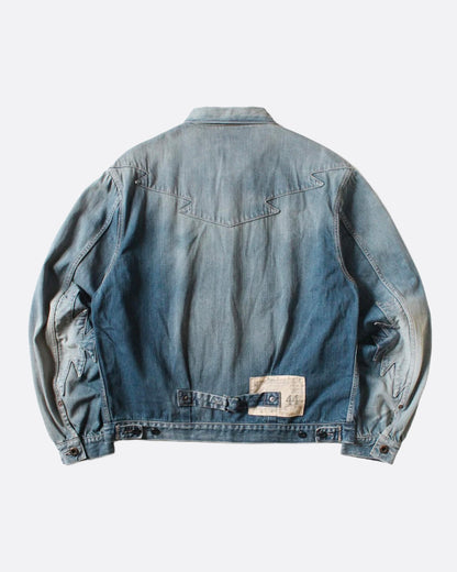 A light blue denim jacket with Chimayo-inspired embroidery across the chest and at each elbow, button closures, and functional back cinch. Shown from the back.