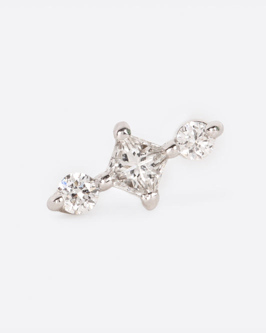 A white gold stud earring with a princess cut diamond at the center and two round diamonds on either side. View from the front.