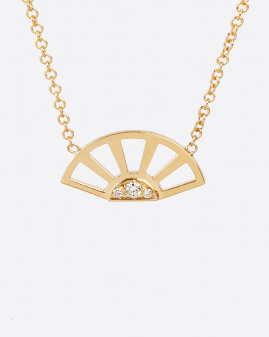 A yellow gold pendant necklace with three white diamonds set at the center of a yellow gold sun and hanging from a yellow gold cable chain. Shown from the front.