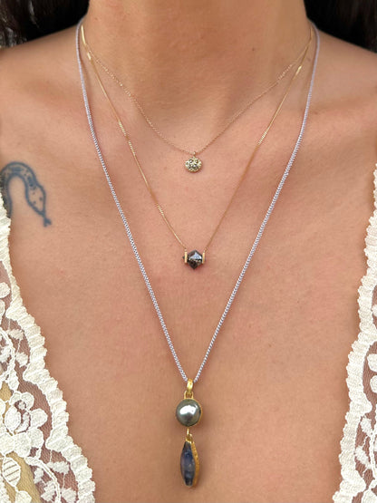 Yellow gold Tahitian pearl and sapphire pendant necklace worn layered with fine gold necklaces