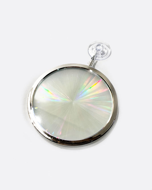A circular rainbow maker with a silver edge and suction cup at the top. Shown from the front.