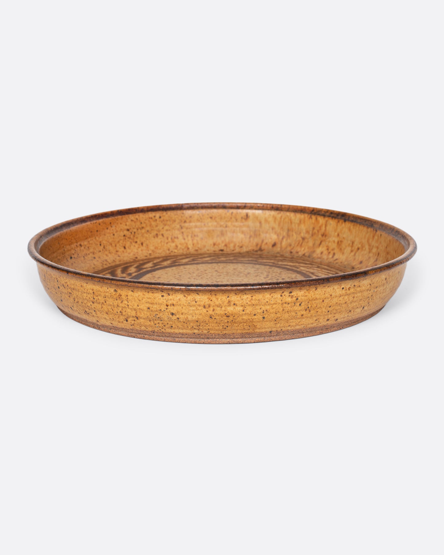 A vintage studio-made ceramic serving platter of generous size, with a swirling center design.