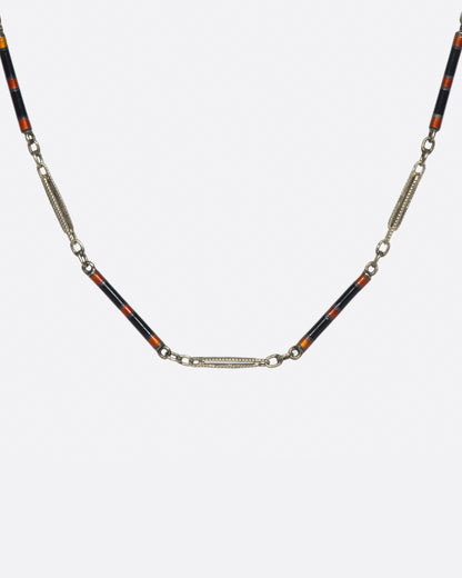 Vintage white gold and enamel bar link necklace, front view of the red and black enamel bars