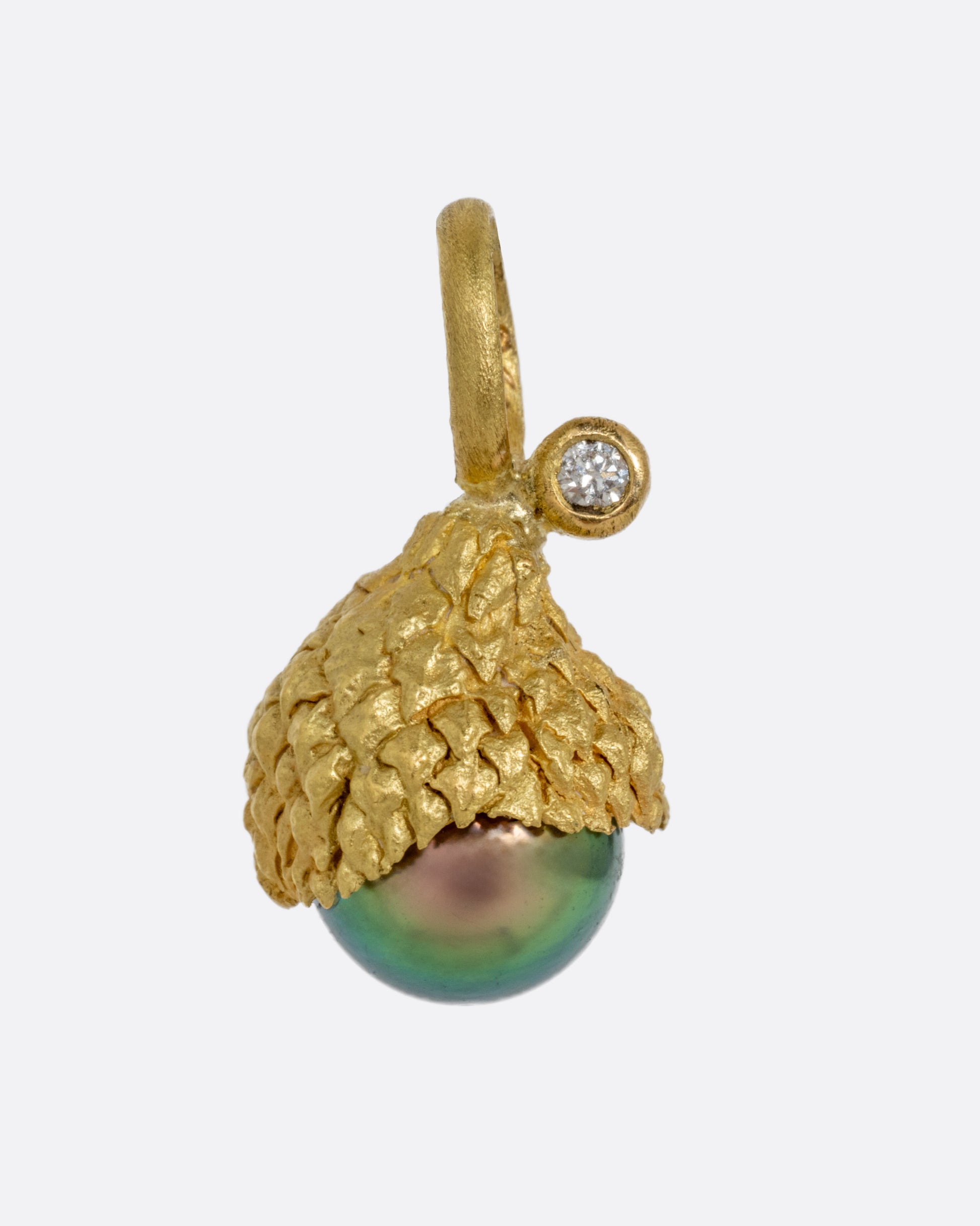 A yellow gold Tahitian pearl charm with a diamond drop. Shown from the front.