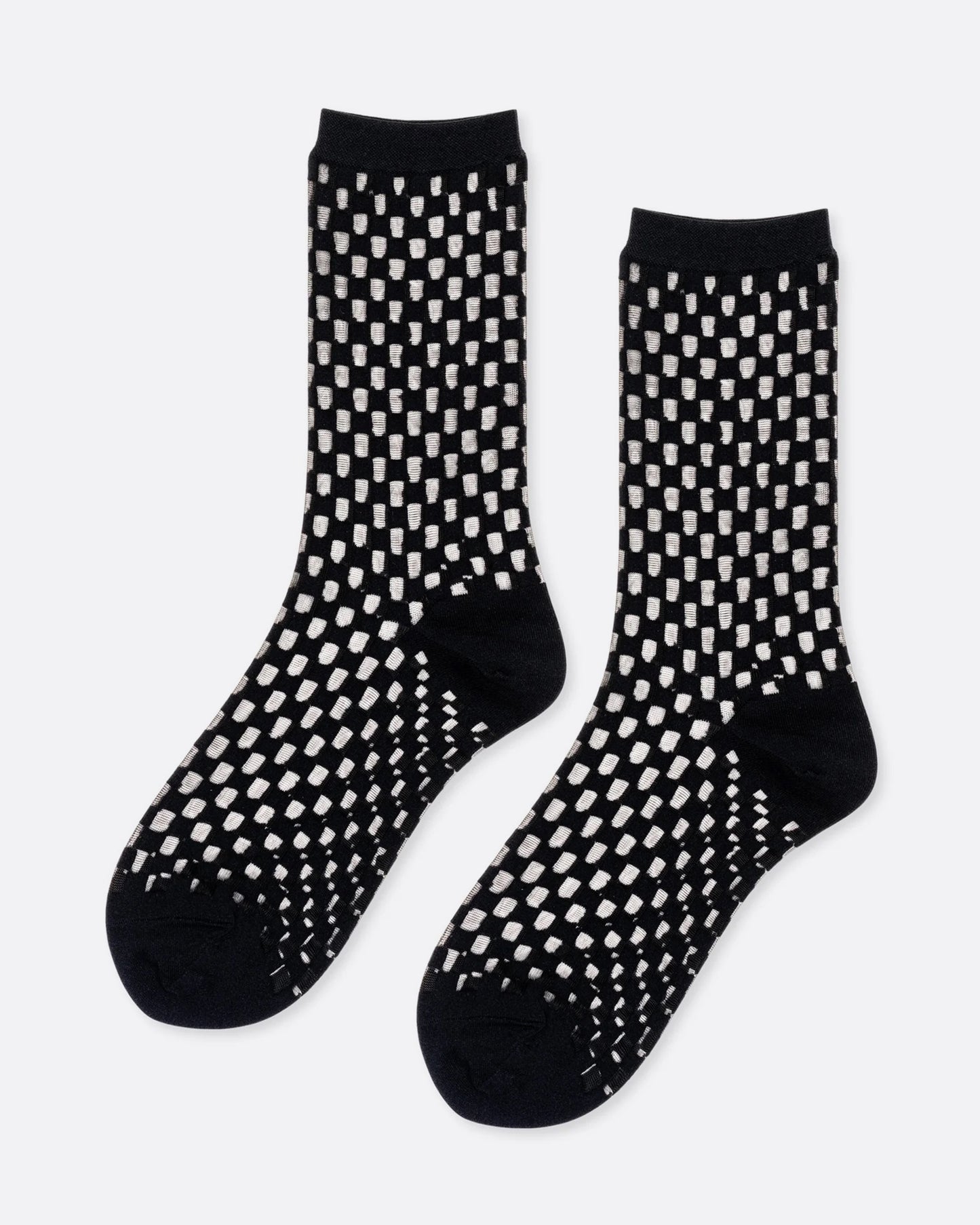 A pair of black and sheer checkered socks, shown from the side.