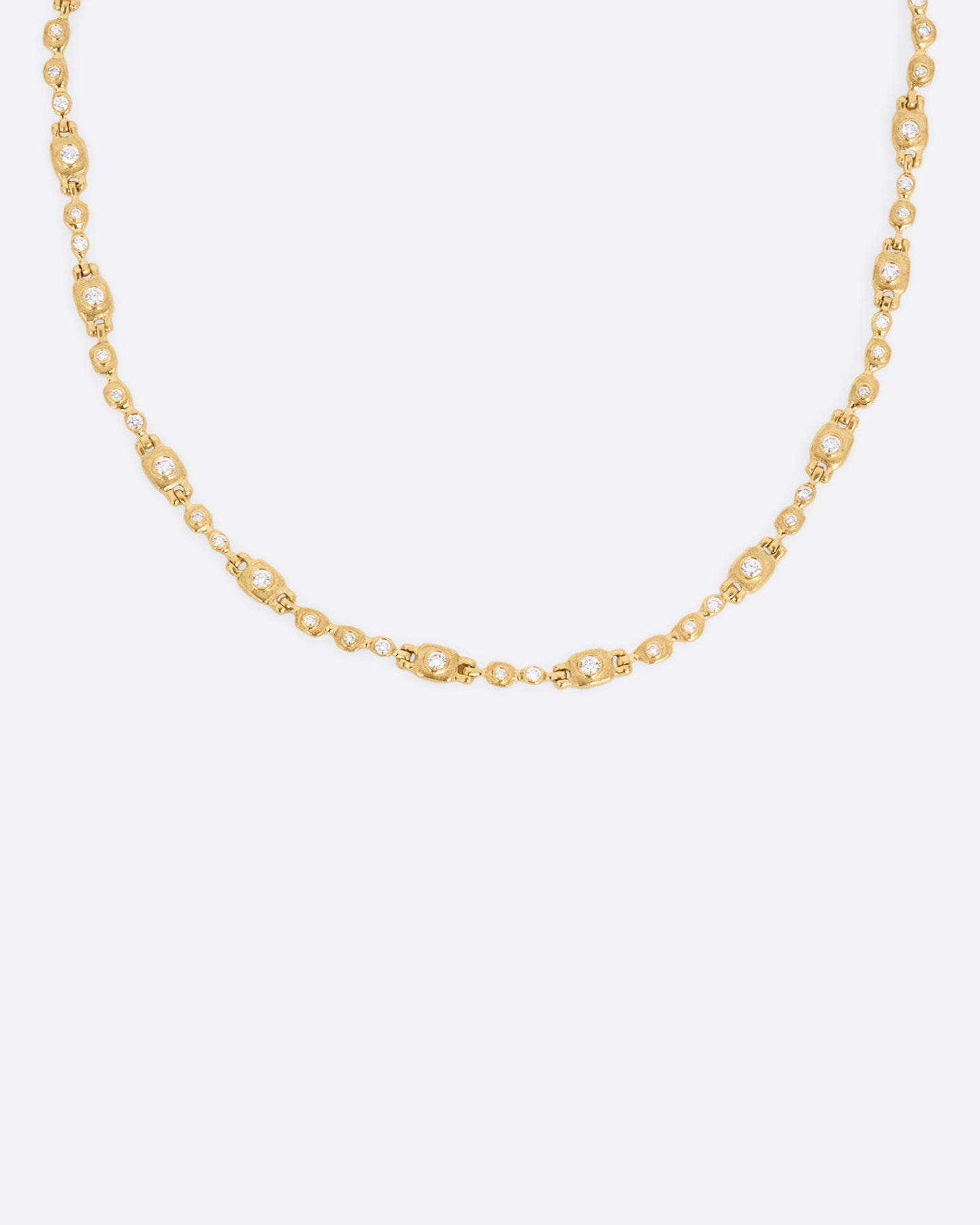 A yellow gold linked necklace with diamonds, shown from the front.