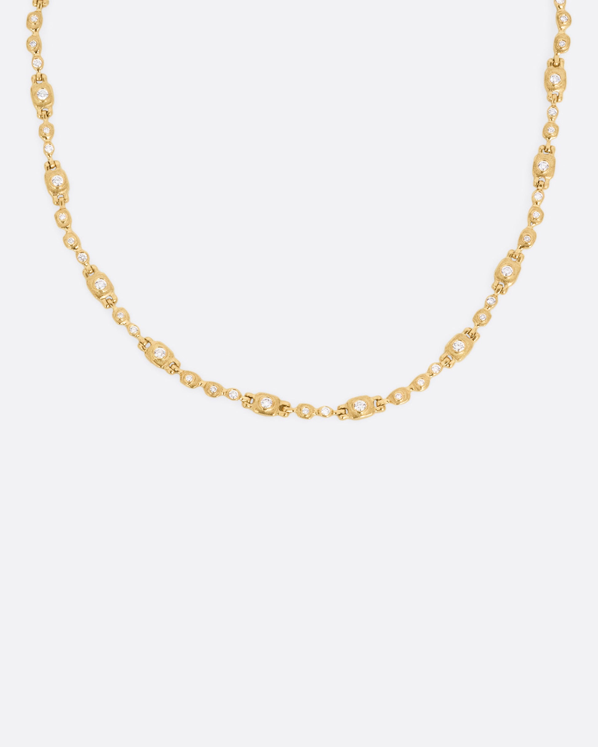 A yellow gold linked necklace with diamonds, shown from the front.
