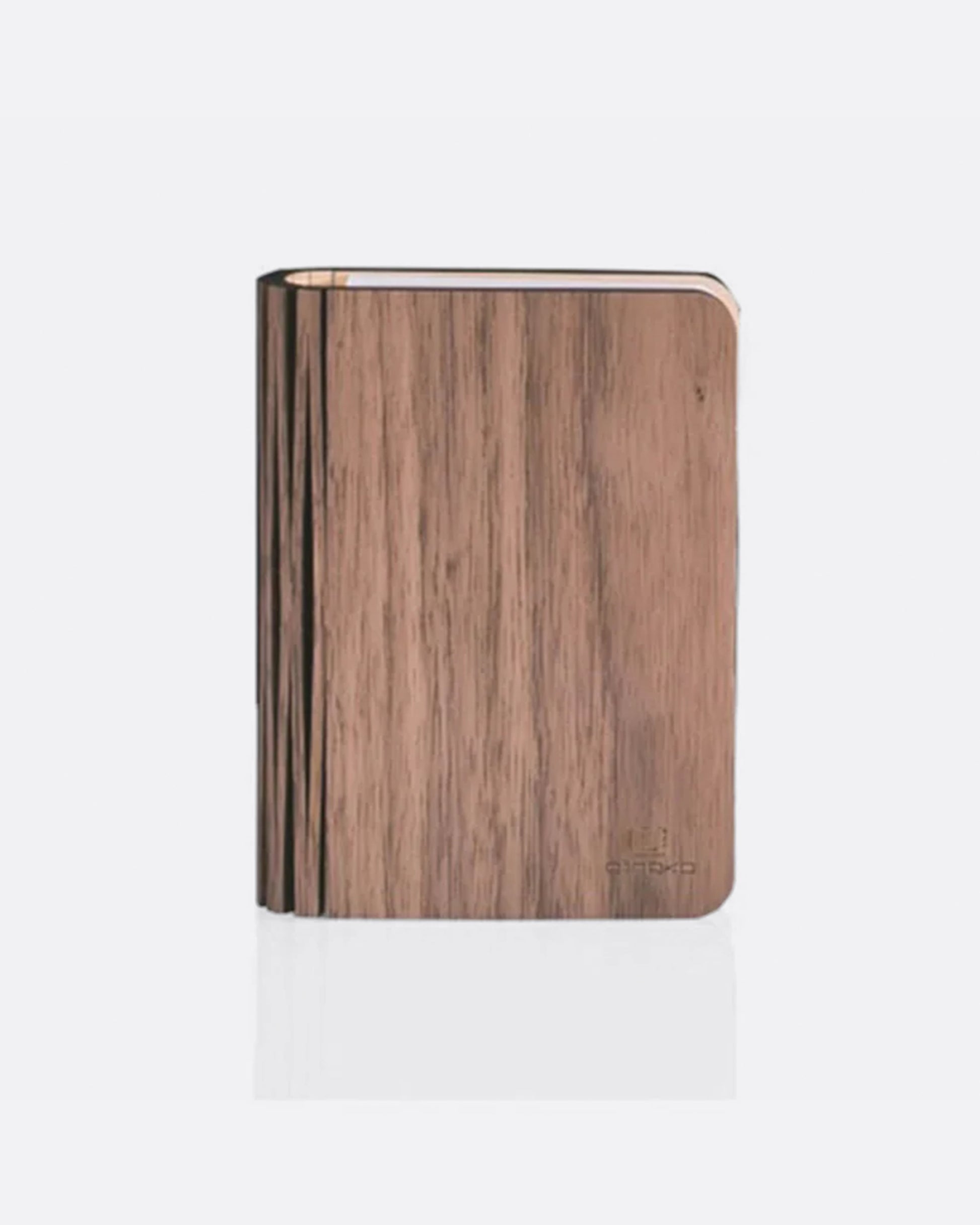 A book shaped light with a laser-cut wooden cover, shown closed from the front.