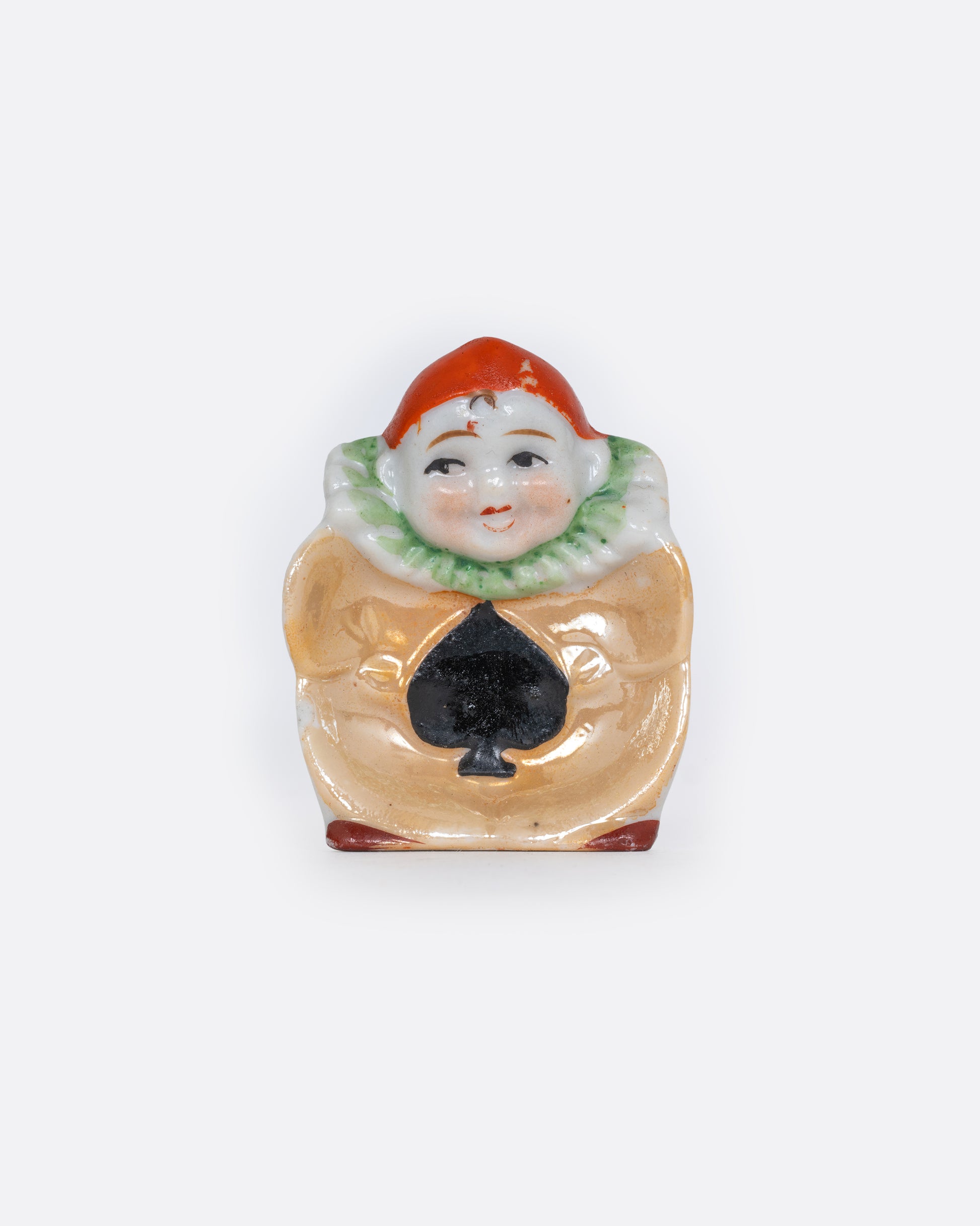 A Japanese harlequin clown dish with a black spade card suit costume. Shown from the top.