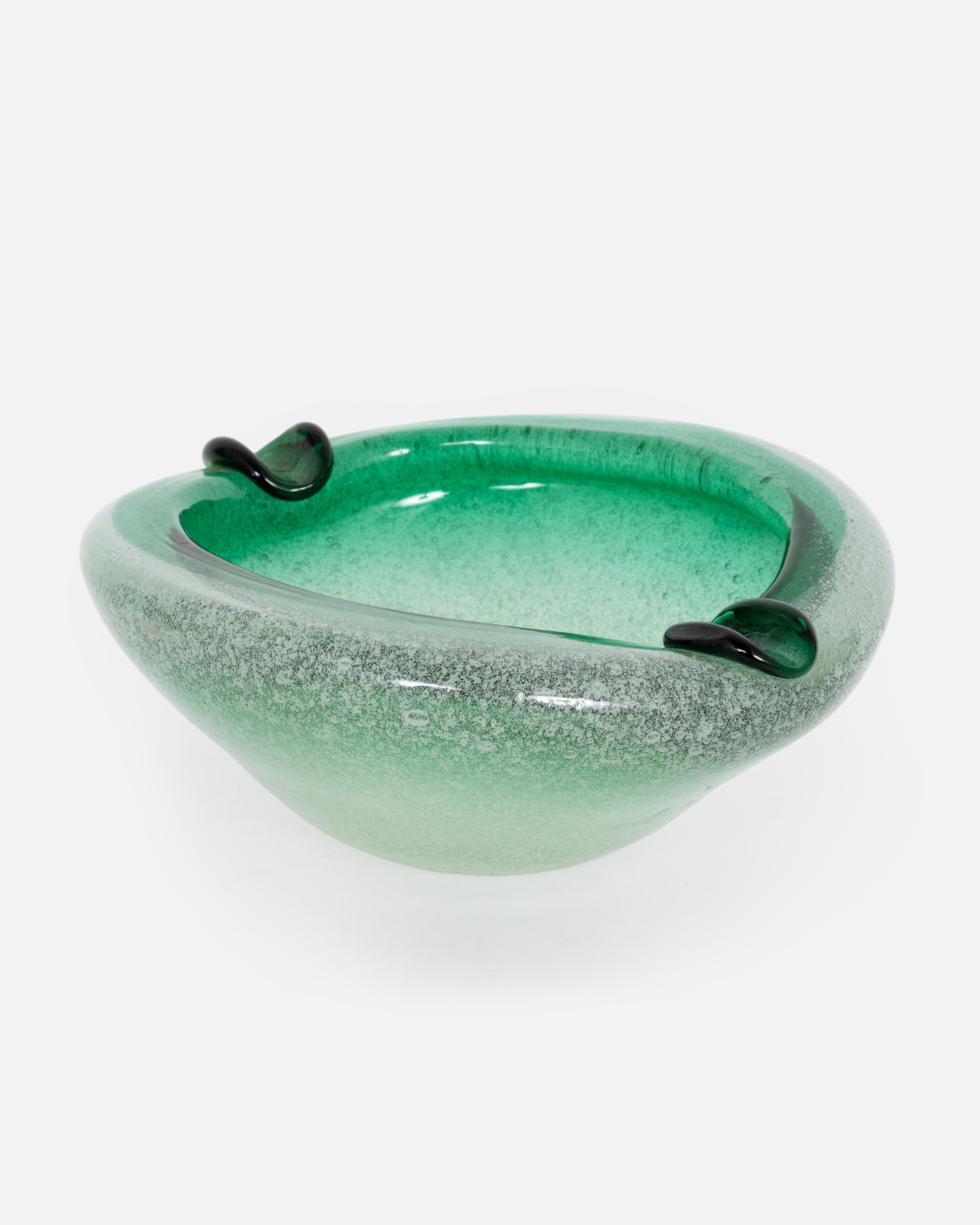 A green blown glass ashtray, shown from the side.