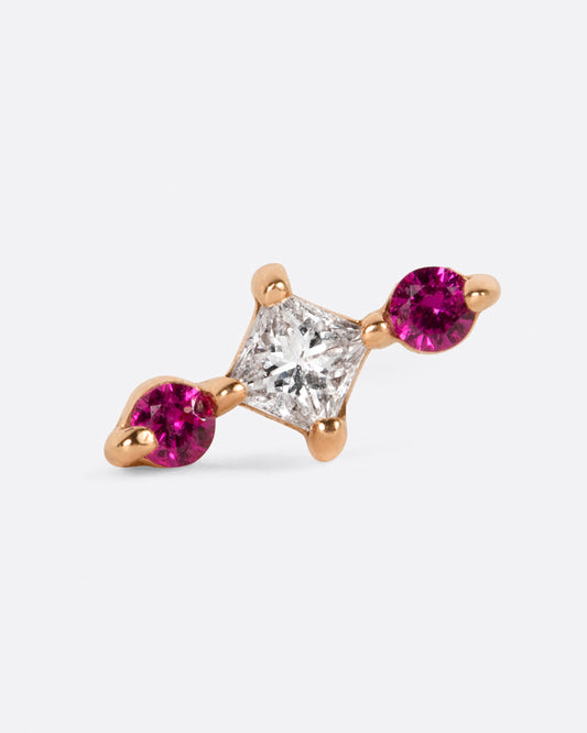 A yellow gold stud earring with a princess cut diamond at the center and two round pink sapphires on either side. View from the front.