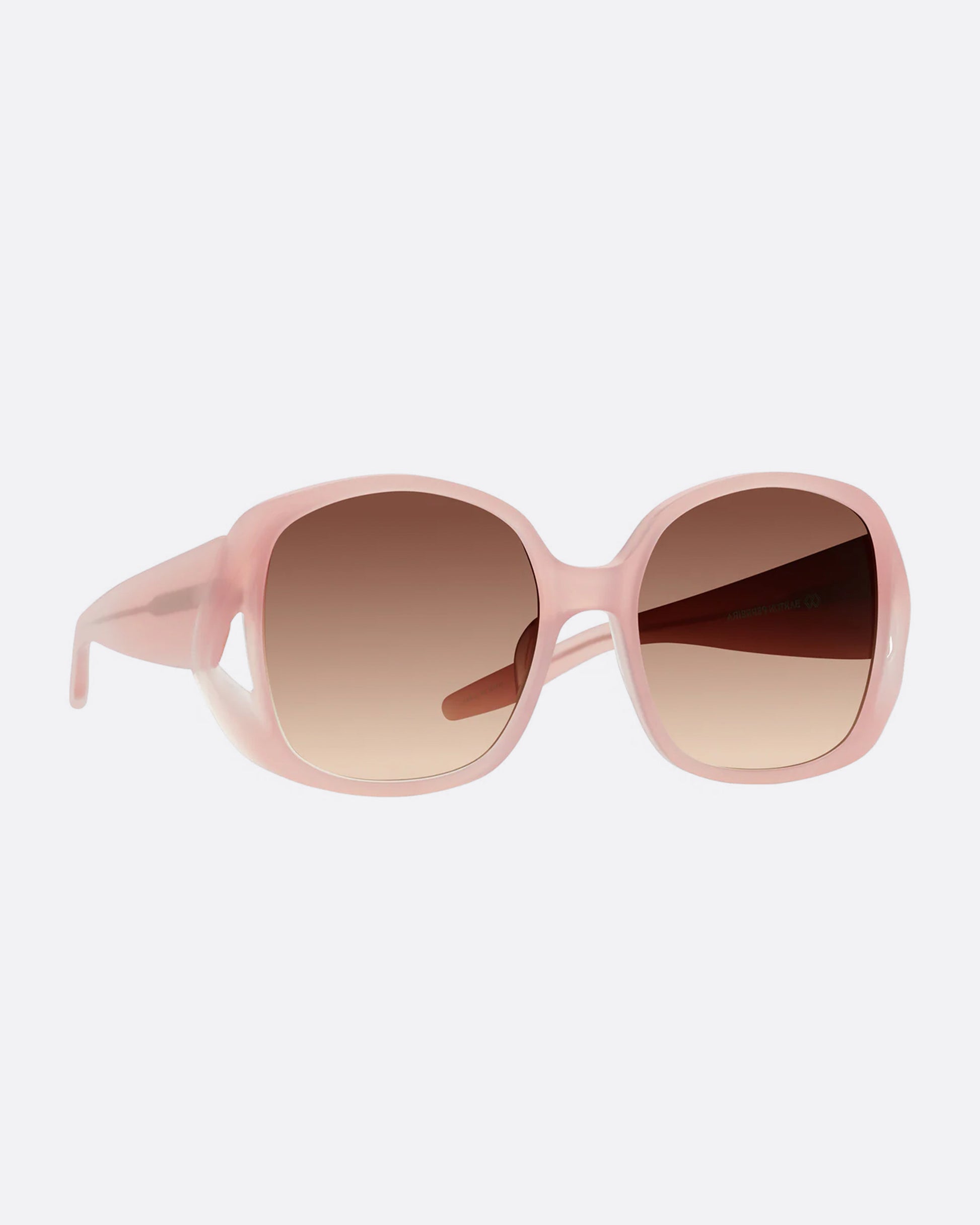 A pair of pink sunglasses with gradient lenses, shown from the side.
