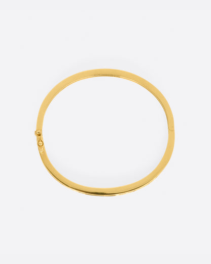 Yellow gold bracelet with alternating sections of channel set rubies and diamonds. View from above.