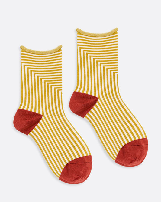 A pair of yellow and white striped socks with orange toes and heels. Shown from the side.